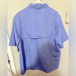 Blue button up vented shirt.